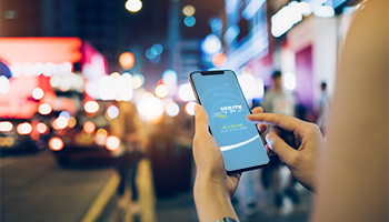 Person checking mobile banking while walking in a city