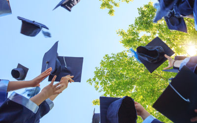 college graduates throwing caps