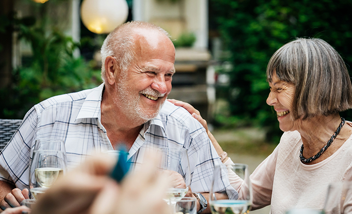 an elderly couple laughing