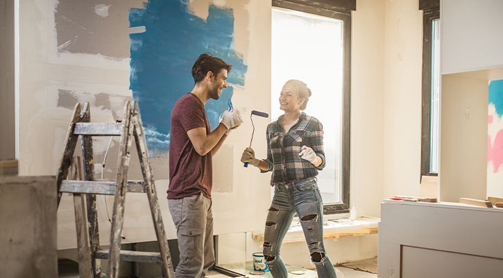 a couple painting and remodeling their house