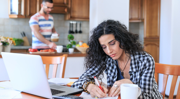 woman sitting at a table banking from home