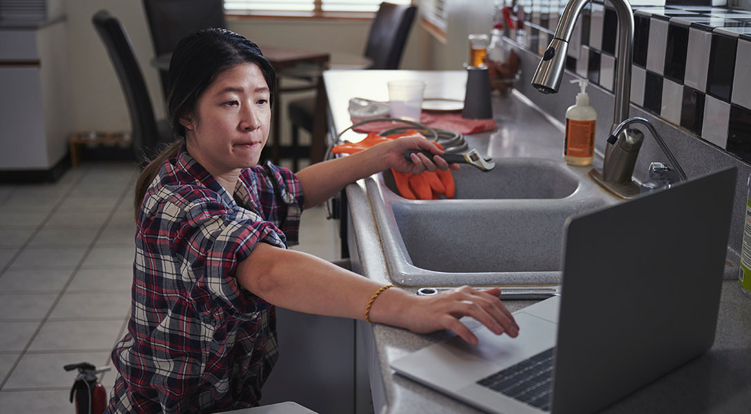 woman working on kitchen sink