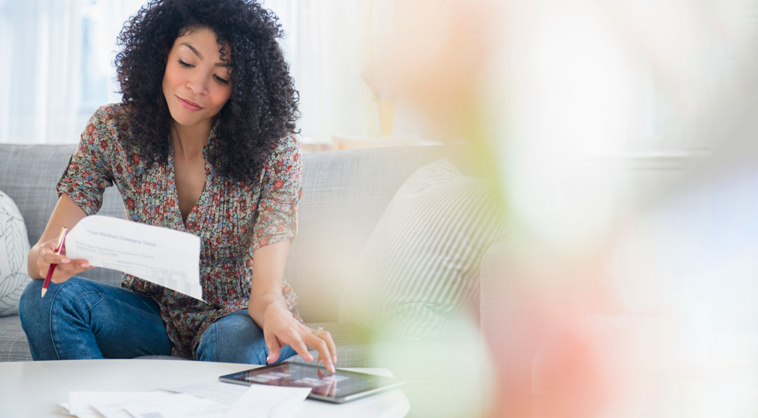 woman paying bills on tablet