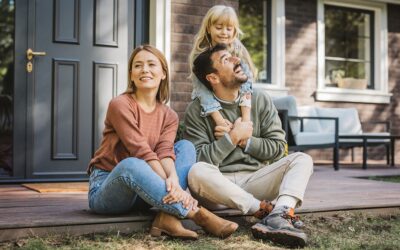 Happy family sitting on their front porch.