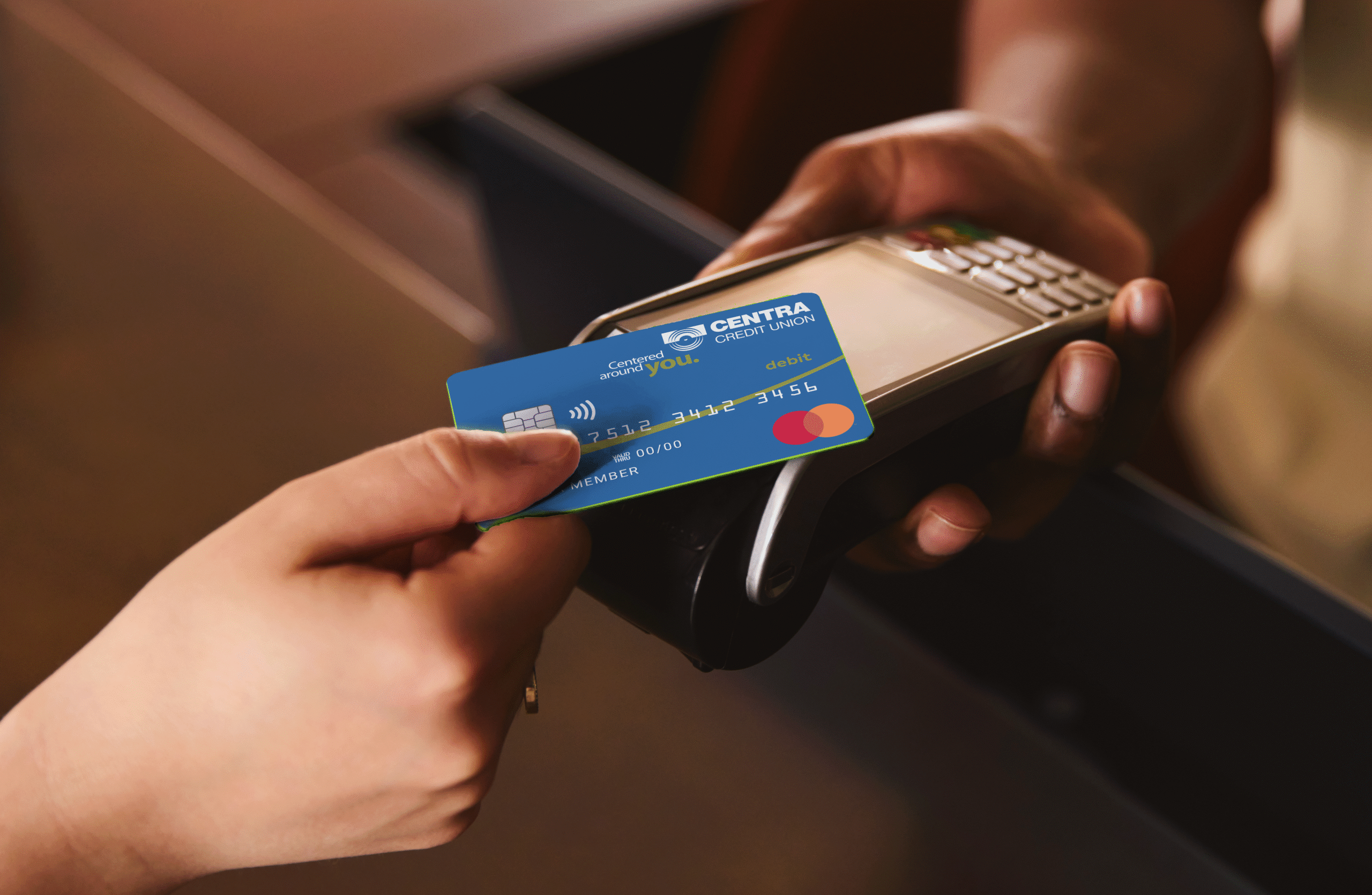 centra debit card tapping pay terminal at retailer